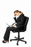 Tiredness modern business woman sitting on chair and using laptop

