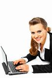 Laying on floor smiling modern business woman using  laptop

