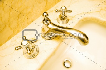 Silver shiny tap and marble sink 