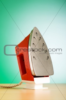 Modern electric iron against the colorful background