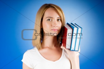 Young university student with many study textbooks