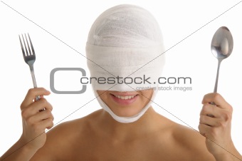 Young woman with bandaged head with plug and spoon