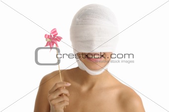 Young woman with bandaged head with toy