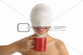 Young woman with bandaged head with red cup