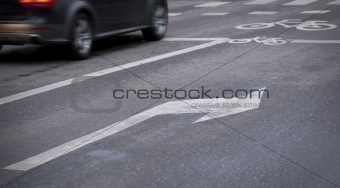 Arrow sign on asphalt