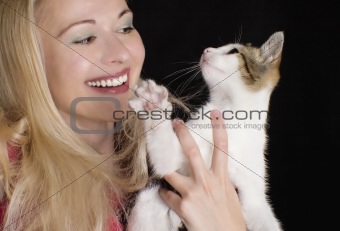 Smiling woman with young cat