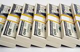 Stacks of One Hundred Dollar Bills on a white background