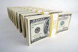 Stacks of One Hundred Dollar Bills on a white background