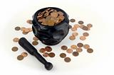 Grinding for Pennies - Wood mortar and pestle containing pennies bills on a white background.