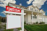 Blank Foreclosure Sign and House with dramatic sky background.