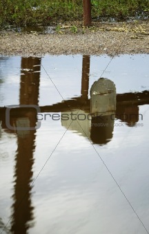 Mailbox Reflected in Puddle