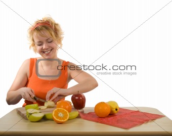 Young mother preparing fruit salad