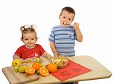 Children eating fruit salad