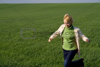Woman rushing through spring field