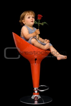 Little girl sitting o red swivel chair