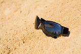Sunglasses reflecting beach view