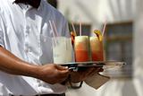 Waiter with fruit cocktails