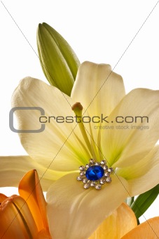 Lilies and a brooch with blue gem