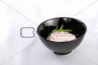 Black plate with cream pink sauce