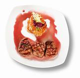 Veal Medallions with potato pancakes. Closeup. File includes cli