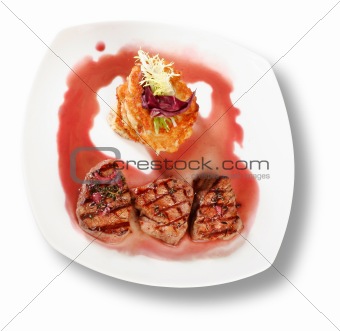 Veal Medallions with potato pancakes. Closeup. File includes cli