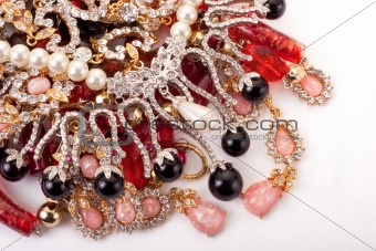 A pile of colored jewellery on white background