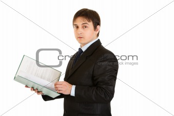Serious modern businessman  holding folder with documents in  hand
