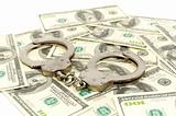 Handcuffs on money background