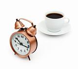 vintage alarm clock and white coffee cup