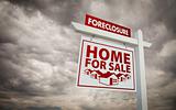 White Foreclosure Home For Sale Real Estate Sign Over Ominous Cloudy Sky.