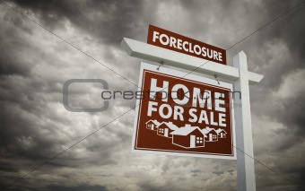 Red Foreclosure Home For Sale Real Estate Sign Over Ominous Cloudy Sky.