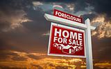 Red Foreclosure Home For Sale Real Estate Sign Over Beautiful Clouds and Sunset Sky.