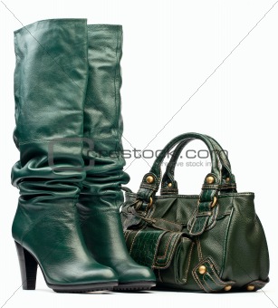 Green female high-heeled boots and leather bag