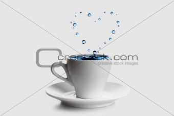 Heart shaped splash in white coffee cup