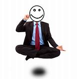 Business man in yoga lotus-pose and  drawing smiling face