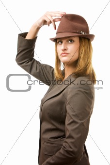 Young woman holding hat and looking at you