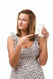 Young woman holding glass of milk in hand 
