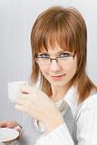 attractive girl in the office with a cup of coffee