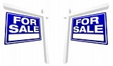 Pair of Blue For Sale Real Estate Signs in Perspective.