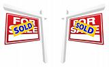 Pair of Red For Sale Real Estate Signs with Sold in Perspective.