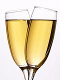 Two glasses champagne on white close up