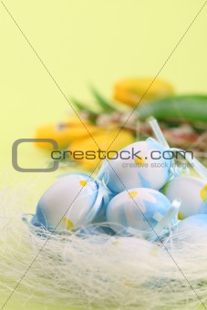 Blue Easter eggs and yellow tulips