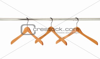 wooden coat hangers on a clothes rail isolated on white