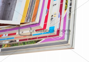 Pile of color magazines isolated on white background