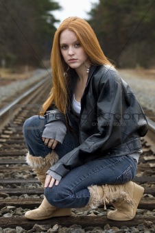 Girl crouching on tracks