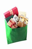 Christmas shopping bag with colorful gift boxes isolated on whit