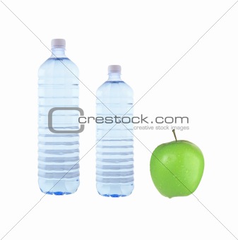 Bottles of water and green apple isolated on white background