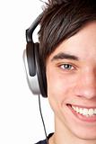Close-up macro of a male teenager listening to music with headphone