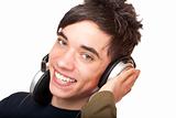 Male Teenager with headphones listens to music and smiles happy