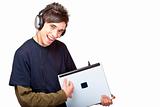 Teenager with headphones plays guitar on laptop